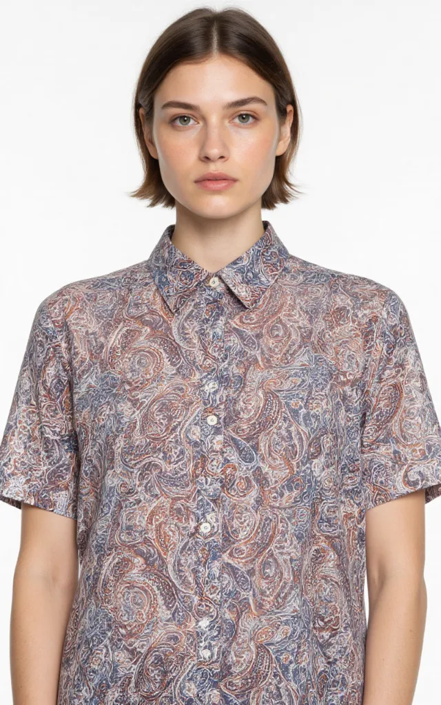A French model wearing a Paisley   inspired pattern   printed shirt, against a white background, in a front   facing bust portrait